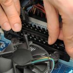 Technician's hands installing user memory on a computer mainboard Technician's hands installing user memory on a computer mainboard