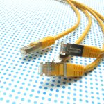 yellow ethernet cable on dotted background yellow ethernet cable on dotted background