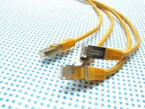 yellow ethernet cable on dotted background
